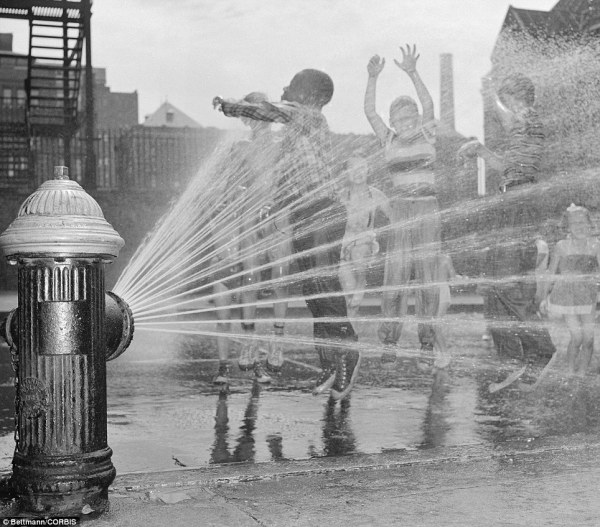 kids playing in fire hydrant in the heat